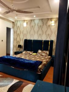 a blue couch in a living room with at Tranquil apartments in Islamabad