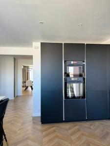 a kitchen with a blue refrigerator in a room at Elena Gestion in Marseille