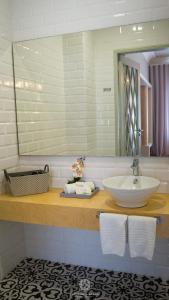 a bathroom with a sink and a mirror at Espinho Vintage - Alojamento de Charme in Espinho +54 photos