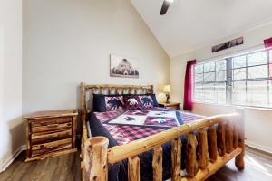 a bedroom with a wooden bed and a window at Smoky View in Gatlinburg