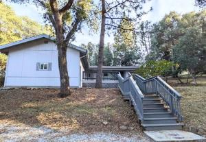 a white house with stairs and a tree at Home in Groveland near Yosemite NP in Groveland