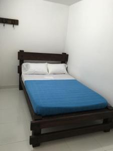 Tempat tidur dalam kamar di RESIDENCIAS CASA BLANCA