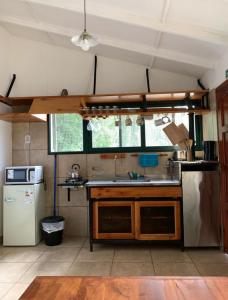 a kitchen with a sink and a refrigerator at Camping El Bolson in El Bolsón