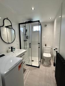 a bathroom with a shower and a toilet and a sink at Cocon tout confort à 25 min de Paris in Sevran