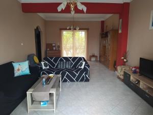 a living room with a couch and a table at Vens apartment 90m2 at Eantio bay. in Aiándion