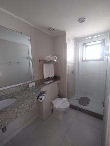 a bathroom with a toilet and a sink and a shower at UH 1116 Flat Live Logde Vila Mariana in Sao Paulo