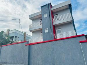 a building with balconies on top of a wall at Central Residence - 1 Bedroom Kigali in Kigali