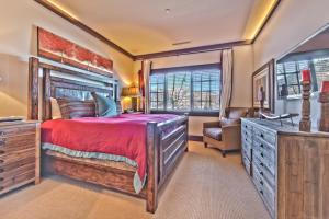 a bedroom with a large bed and a chair at Year Round Recreation Luxury Resort Amenities and Hot Tub Access! Deer Valley Arrowleaf 211 in Park City