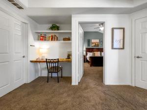 a hallway with a desk and a chair in a room at BEAUTIFUL condo with POOL, SPA & GARAGE! townhouse in Litchfield Park