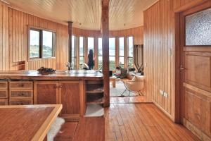 a kitchen with wood paneling and a large counter top at Casa Barco Chiloe in Quilquico