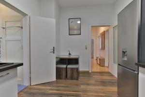 a kitchen with a sink and a hallway at Studio Suite mit Service wie im Hotel in Göppingen