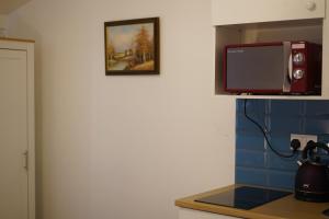 a kitchen with a microwave and a counter top at City Nest Studio #3 in London