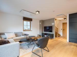 a living room with a couch and a table at Schletski in Donnersbachwald