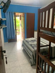 a bedroom with a bunk bed and a open door at SUITES Recanto do DO Mar in Saquarema