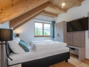 a bedroom with a bed and a flat screen tv at Haus Elau in Donnersbachwald