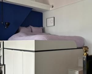 パリにあるLarge studio near Père-Lachaiseの青い壁のベッドルーム1室