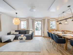 a living room with a couch and a dining room table at Bergzauber in Donnersbachwald