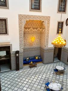 a living room with a blue couch and a fireplace at Riad Dilar Fes & Spa in Fez