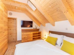 a bedroom with a white bed and a tv at Chalet Thor in Donnersbachwald