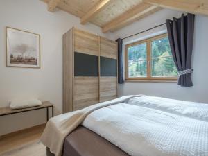 a bedroom with a large bed and a window at Haus Laura in Donnersbachwald