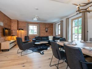 a living room with a table and chairs and a couch at Villa Petra in Donnersbachwald