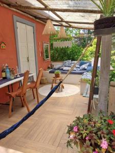 a patio with a hammock in a room with a table at casadamaro in Santa Maria Madalena