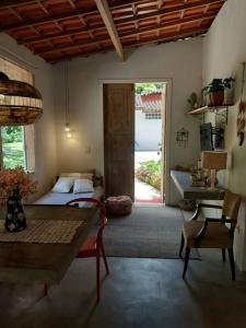 a bedroom with a bed and a table and a door at casadamaro in Santa Maria Madalena