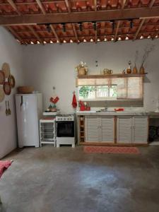 a kitchen with a white refrigerator and a stove at casadamaro in Santa Maria Madalena