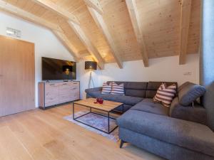 a living room with a couch and a table at Apart Heidi in Donnersbachwald