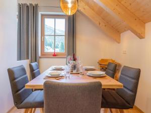 a dining room with a wooden table and chairs at Apart Heidi in Donnersbachwald