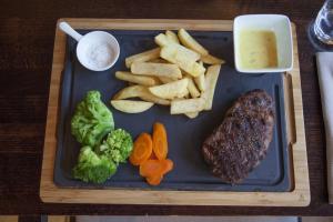 a tray with steak and chips and broccoli and vegetables at Auberge de Vianden in Vianden +20 photos