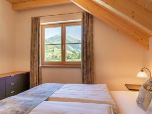 a bedroom with a bed and a window at Apart Heidi in Donnersbachwald