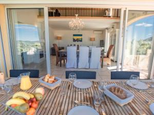a dining room with a table with food on it at La Parure in Vidauban