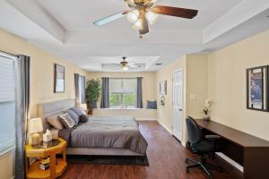 a bedroom with a bed and a ceiling fan at Bamboo Oasis-Relaxing Hot Tub-Family Time in San Antonio