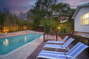 a group of chairs sitting next to a swimming pool at Bamboo Oasis-Relaxing Hot Tub-Family Time in San Antonio