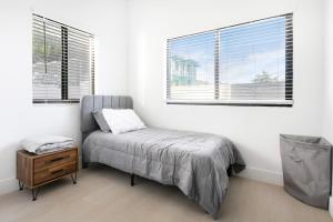 a bedroom with a bed and two windows at Horizon West in Nassau