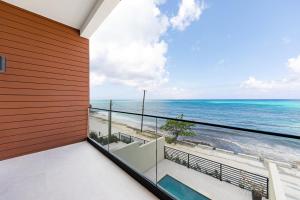 a balcony with a view of the ocean at Horizon West in Nassau