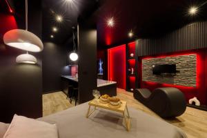 a living room with a bed and a table with a table at Suite Deluxe - Jacuzzi in Melun