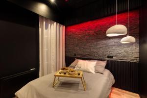 a bedroom with a bed and a table with food on it at Suite Deluxe - Jacuzzi in Melun