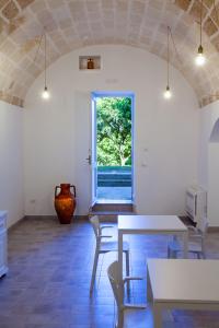 a room with a table and chairs and a window at Villa Marta in Taranto