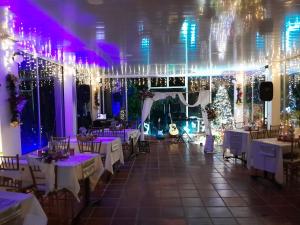 a banquet hall with white tables and christmas decorations at Hotel campestre Villa Sarita in San Francisco