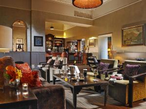 a lobby with couches and tables and a bar at Great Southern Killarney in Killarney