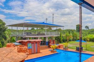 a resort with a pool and a pavilion at Hotel Quimbaya Dorado in Quimbaya