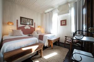 a hotel room with two beds and a window at Hotel Punta Descartes in La Cruz