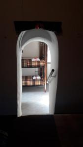 an archway leading to a room with a bunk bed at Πέτρινο σπίτι-Stone house in Koíta
