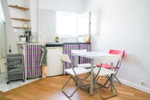 a kitchen with a table and chairs in a room at Lovely cocoon with a view over Paris in Paris