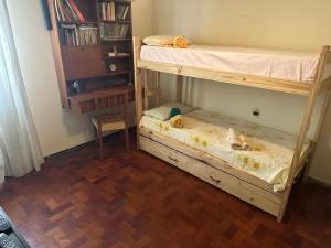 a bedroom with two bunk beds and a wooden floor at CASA PATRICIAS in Godoy Cruz