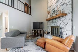 a living room with a couch and a fireplace at Large Luxury Private 5BDRM Home With Heated Pool in Billings