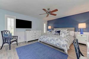 a bedroom with a bed and a ceiling fan at Surrounded By Sea Breezes - Anna Maria, FL in Anna Maria