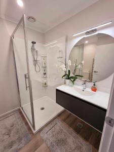 a white bathroom with a sink and a shower at Cosy homestay in Upper Hutt in Upper Hutt